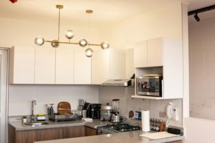 A modern kitchen with bar stools.